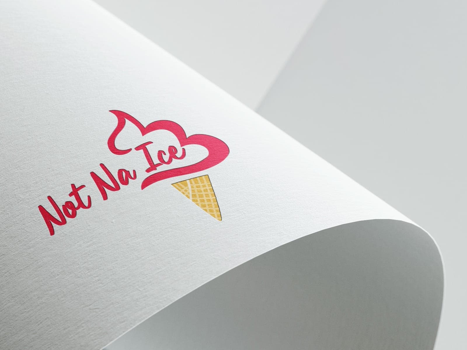 The Not Na Ice script logo in raspberry red, with a soft-serve swirl and a waffle cone, printed on a curled sheet of textured white paper.
